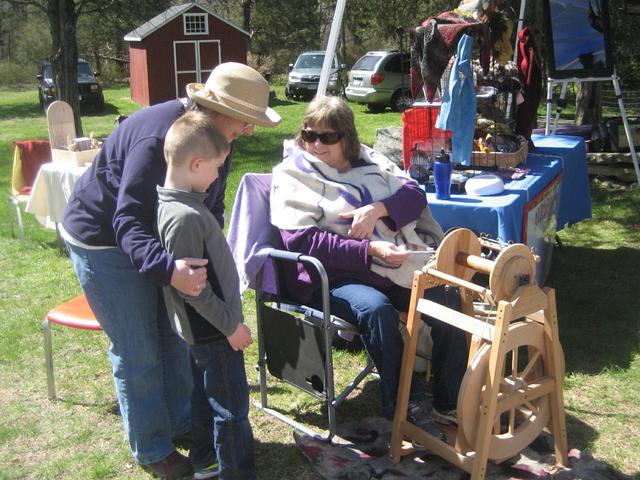 16 Rose East showing a young boy her spinning wheel 4-16-16.jpg